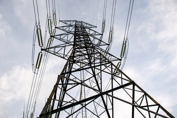 Electricity pole against blue sky clouds in dawn time, Transmission line of electricity to rural,...