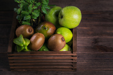 Set of green fruits for healthy diet and detox: apple, lime, kiwi, mango, carambola and mint.