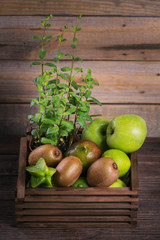 Set of green fruits for healthy diet and detox: apple, lime, kiwi, mango, carambola and mint.