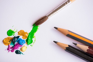 Oil paint, brush, and pencils.