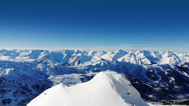 fly over snowy mountain peak in Alps