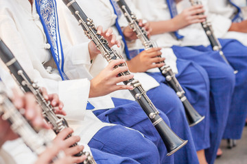 Teen Band in white-blue uniform performing.