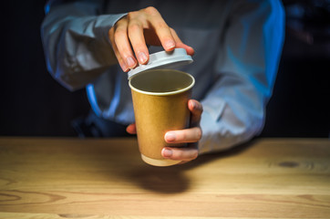 Barista serves coffee to the client. Hands Paper cup Bar counter Cappuccino Plastic cap. Coffee Business Concept