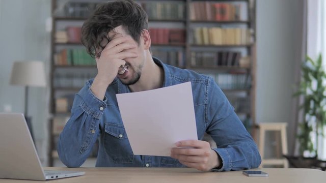 Young Man Devastated by Rejection, Failure of Business Proposal, Holding Documents