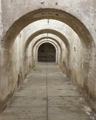 A view of a tunnel with arch and raw walls