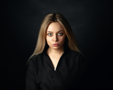 Portrait Of A Beautiful Woman On A Dark Background