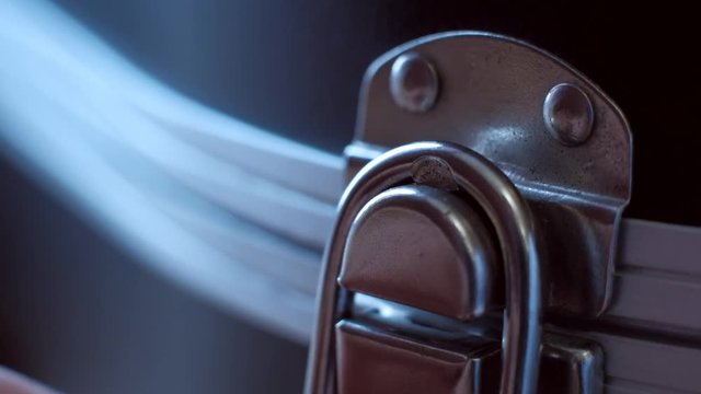 musician closes guitar case extreme close-up. 4k. macro shoot.