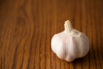 Garlic bulb on the wooden vintage background