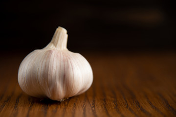 Garlic bulb on the wooden vintage background