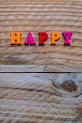 Lettres en bois de couleur, message Happy, arrière plan bois