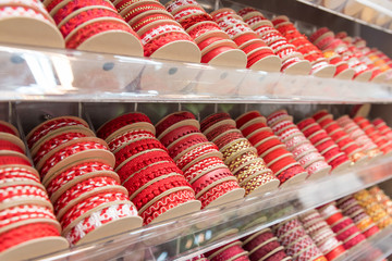 Plenty of Purpose Glossy Colored Rolled Ribbons Piled on shelf Display red tone Color. ribbon roll for stitching on shelves Selling to decorate new year gifts, fashion clothes and other festivals