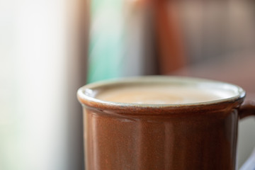 Close up of mug cup of hot coffee latte with milk foam. Relax, Food and drink concept.