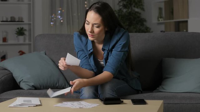 Angry woman claiming wrong receipt calling on phone sitting on a couch in the night at home