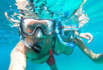Underwater view of snorkeling couple in the sea