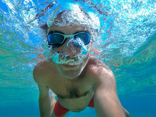 Underwater view of a diver man swimming