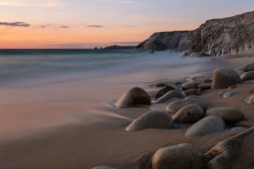 French landscape - Bretagne. A beautiful beach with wild cliffs in the background at sunset.