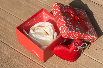 Blooming white rose inside the gift box on wooden background, Valentines day card concept, Top view on romantic composition