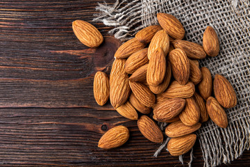 Almond on dark wooden background.