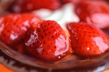 Cake with strawberries and ice cream photographed close-up.