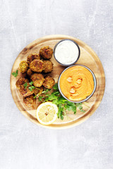 Traditional homemade hummus, falafel and chickpea served with spices on table. Jewish Cuisine.