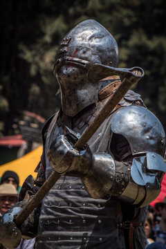 Medieval knights fighting with armor, swords and shields in festival