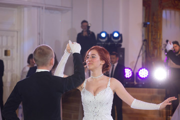 Young good looking couple in evening dress and dress coat posing in elegant way in a classical style