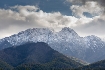 Giewont Mountain in polish Tatra Mountains covered with snow under cloudy sky