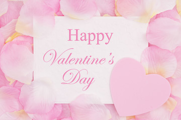 Happy Valentine's Day greeting card on pink rose flower petals