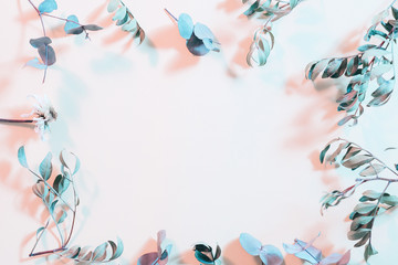 Obraz premium Creative foliage layout. Floral arts. Dry stems frame on pink background.