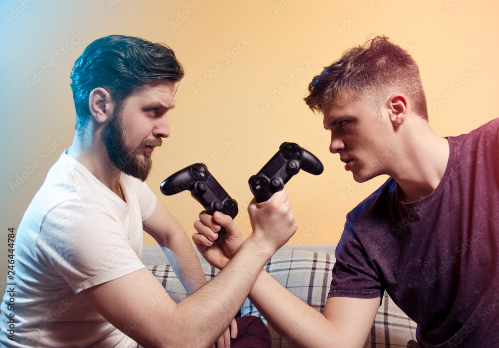 Wall mural Two gamers head to head, red and blue player with game controllers, tournament , competition concept 