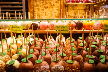 Traditional Christmas German delicacy - sweet apples in different kinds of chocolate - on the counter of the Christmas fair in Frankfurt am Main, Germany