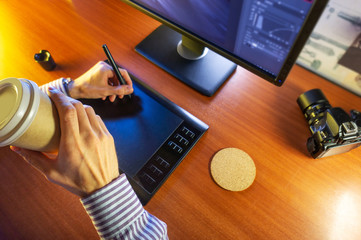 Desktop side view. Computer Graphics Tablet Diary Cup of coffee Hand. Concept for website banner,...