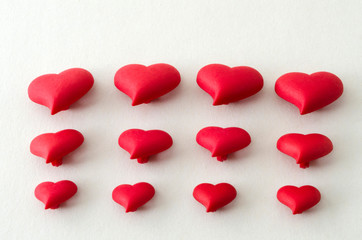 A few of little red hearts for Valentine's Day against white background