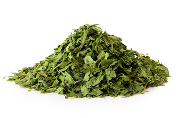 A pile of dried chopped parsley isolated on white.