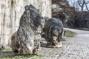 Sculpture of marble lions, a symbol of the city of Brescia, are installed in the park of the castle. Lombardy, Italy.