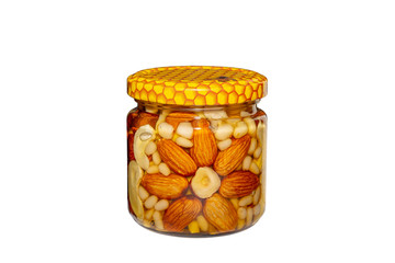 Jar of nuts in honey isolated on white background
