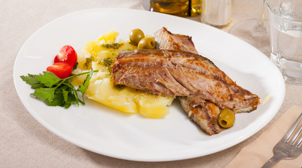Delicious fried mackerel fillets with mashed potatoes, olives and tomatoes