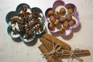 The cinnamon sticks, nuts and star anise on the table.