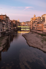 Fototapeta na wymiar Girona's skyline famous landmark river view at the sunset. Onyar river and Cathedral skyline cityscape in famous city in Catalonia