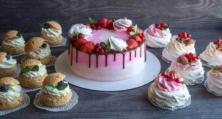 biscuit cake with strawberry, red currant and meringues