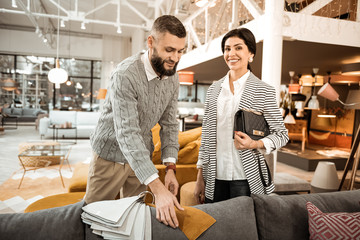 Brunette good-looking woman with wide smile carrying bag