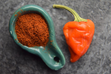 Raw ripe fresh red pepper with powder spice