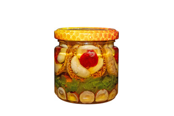 Jar of nuts in honey isolated on white background