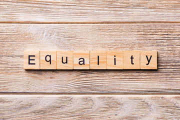 Equality word written on wood block. Equality text on wooden table for your desing, concept