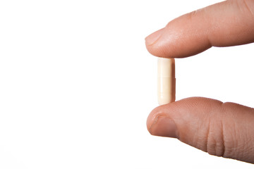 human hand with one pill, isolated on white