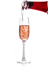 pouring pink wine into glass, isolated on white background