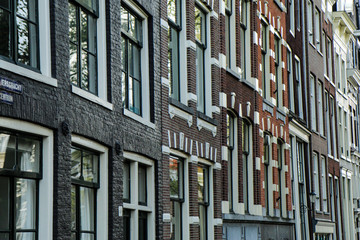 The detail of the houses in Amsterdam in Netherlands. The typical facades of the buildings. 