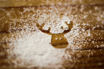 Fototapeta na wymiar Ingredients for cooking Christmas baking: fir deer made from flour on a light table, kitchen utensils, top view.