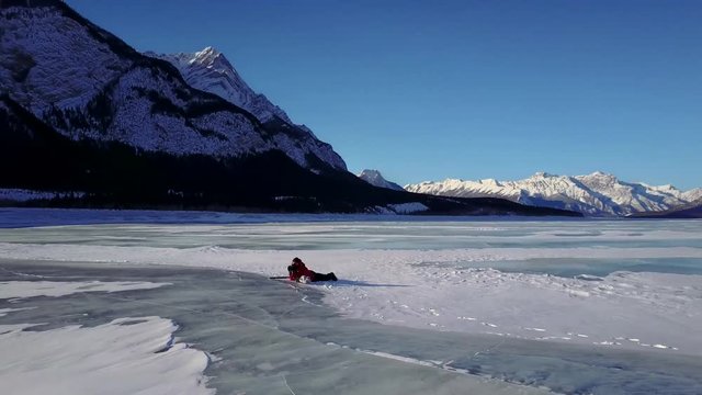 4k Aerial circling drone shot Abraham Lake in Alberta Canada. Photographer in the middle of the shot.