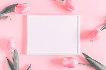 Flowers composition romantic. Flowers pink tulips, photo frame on pastel pink background. Wedding. Birthday. Happy woman's day. Mothers Day. Valentine's Day. Flat lay, top view, copy space 